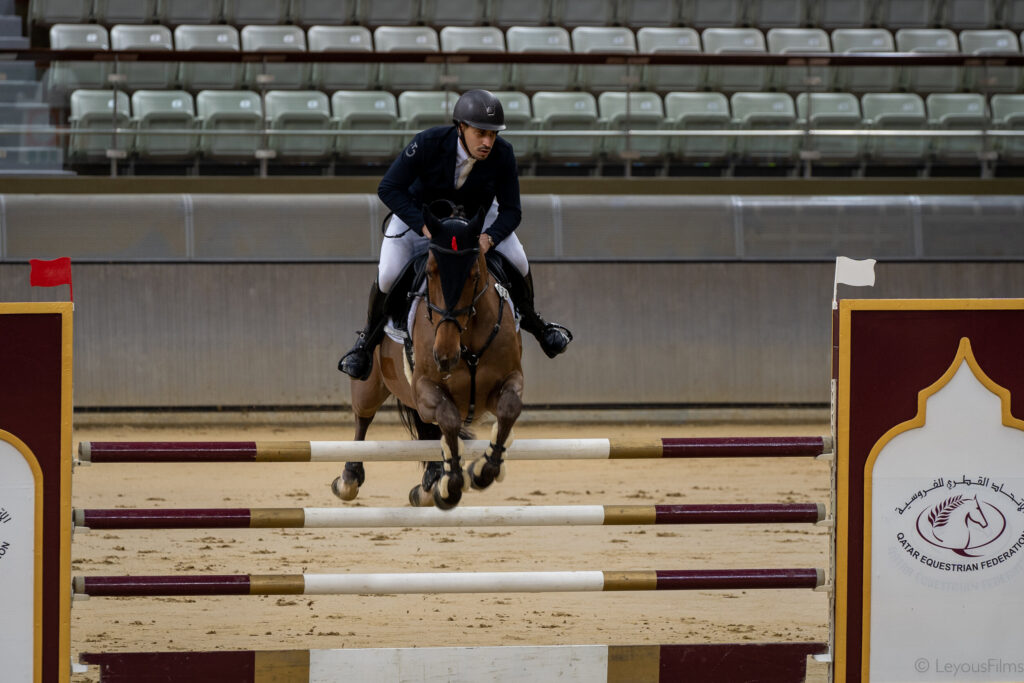 Life in Strides — horse and rider clearing a jump in competition