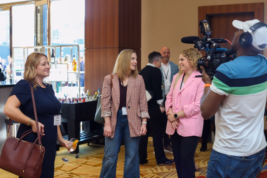 AmeriFilms founder Souley Oumarou filming guests at a business event in a hotel ballroom